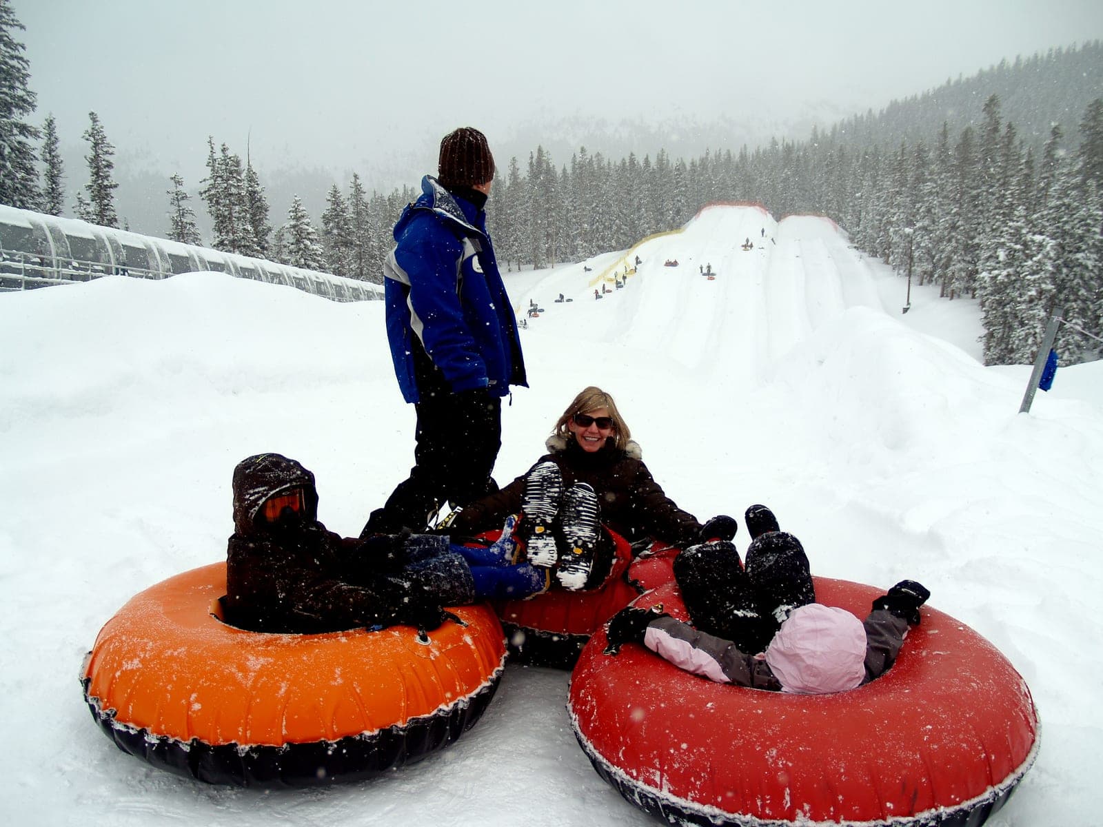 Family snow tubing at a mountain resort