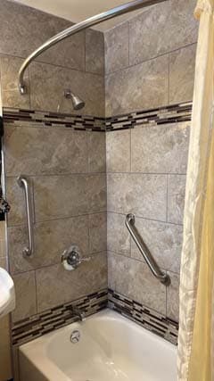 Renovated tub and shower in a Briarcliff guest room