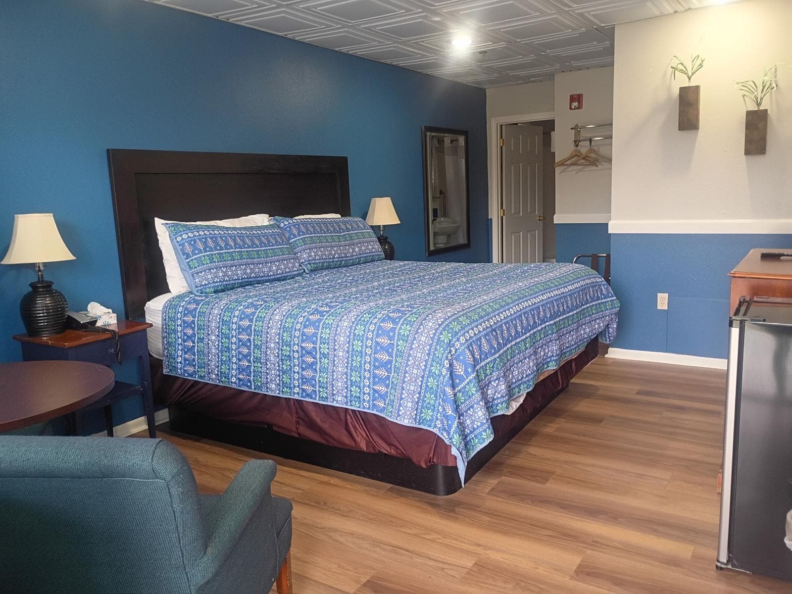 King bed with blue Nordic-pattern bedding in a renovated Briarcliff guest room