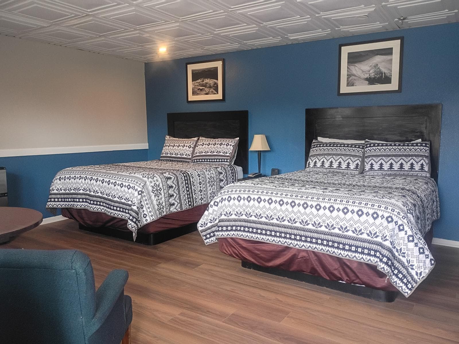 Two queen beds with Nordic snowflake bedding and framed White Mountains prints